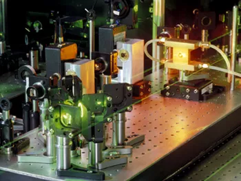 A photograph of a laser system on a table in a laboratory.